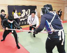 刺股を使って侵入者役の署員を追い詰める社員ら＝津島署で