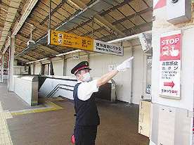 マスク姿でホームに立ち、安全確認をする小嶋さん＝愛知県安城市の東海道新幹線・三河安城駅で（ＪＲ東海提供）