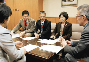 牧義夫・厚生労働副大臣（右）に労働者派遣法改正案の早期成立を要請する鴨桃代会長（右から２人目）ら＝９日、厚生労働省で