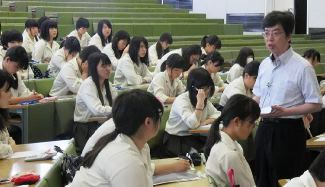 四日市商高の生徒たちに会計の魅力を語る朝日大の小島一富士教授（右）＝瑞穂市穂積の朝日大で